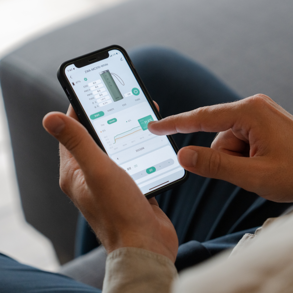 Person using Zenwell mobile app to check air quality detected by Baby Safe Air Purifier Smart