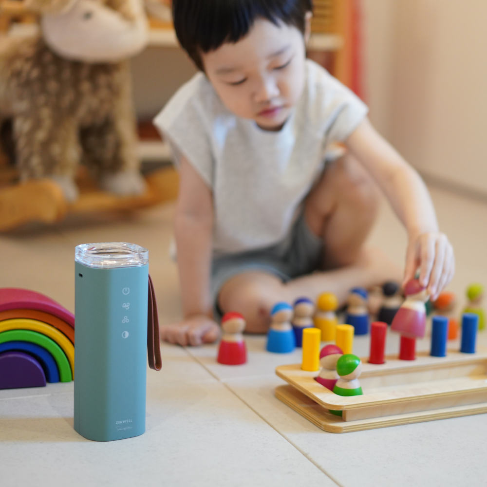 Baby Safe Air Doctor on floor in front of toddler playing with toys