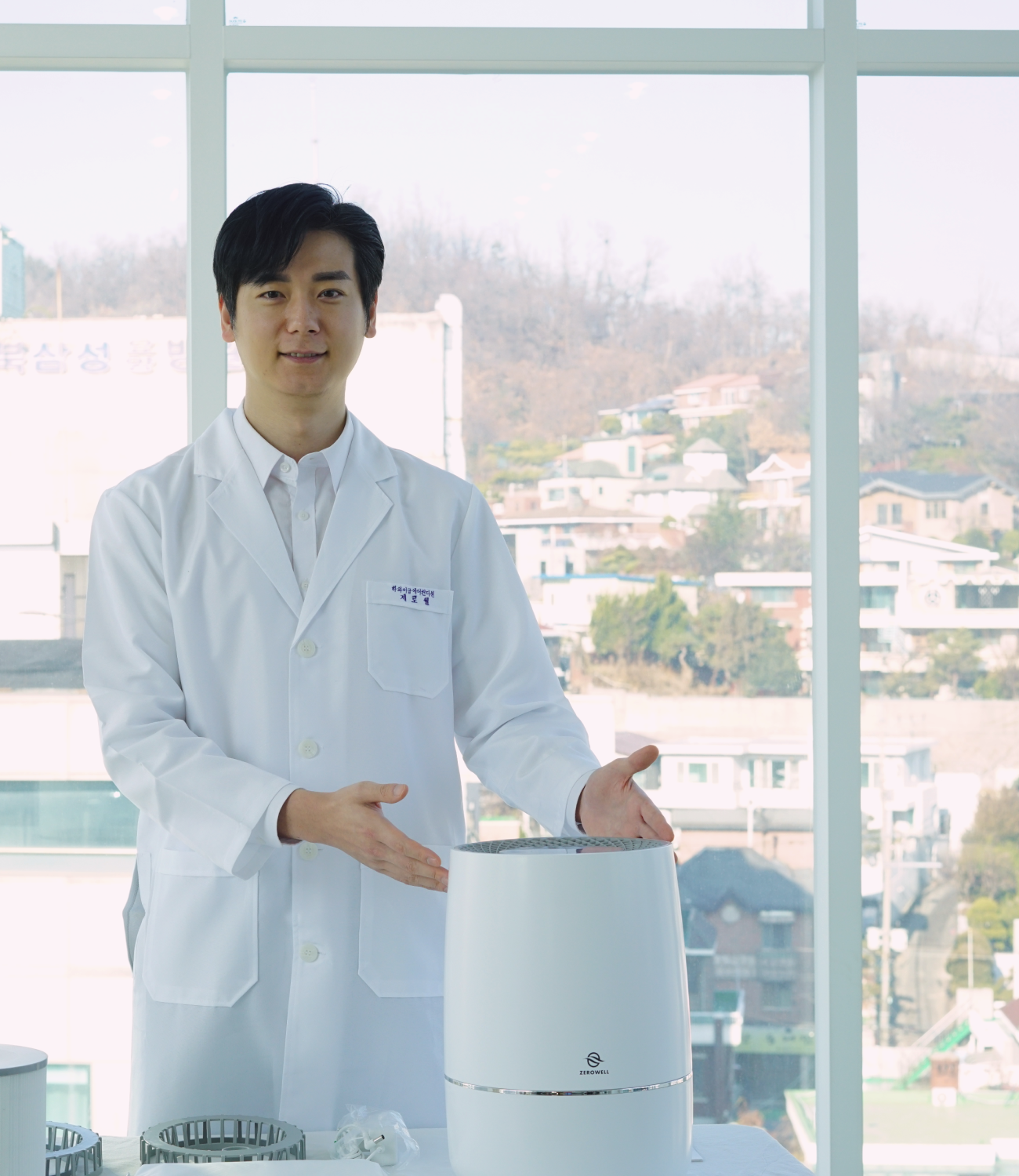 Company founder in lab coat gesturing to Zenwell appliance