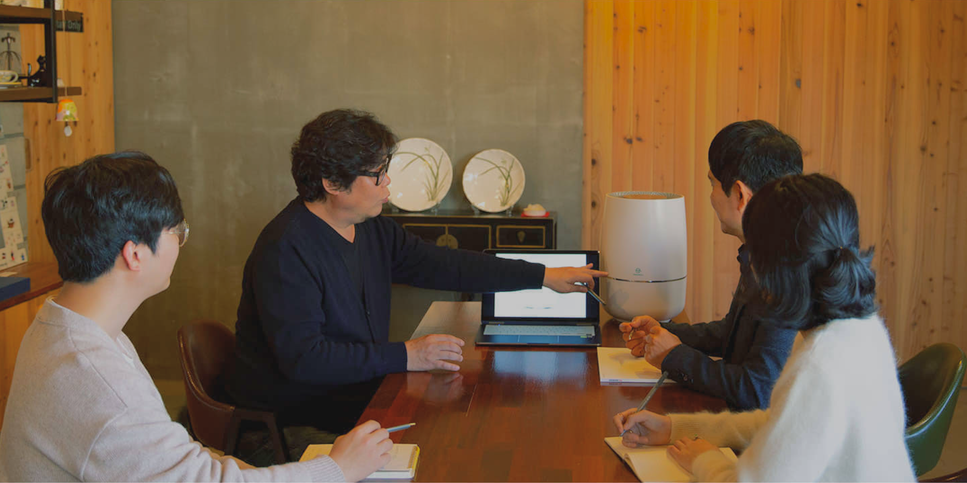 Zenwell design team at table discussing details of Zenwell appliance