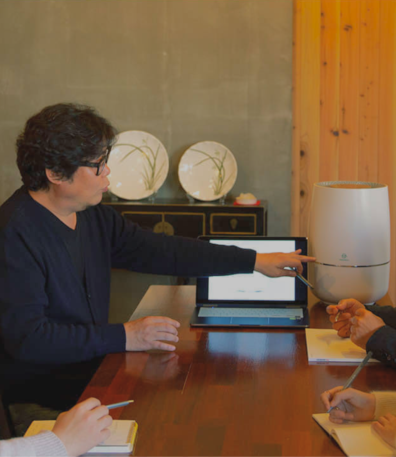 Zenwell design team at table discussing details of Zenwell appliance