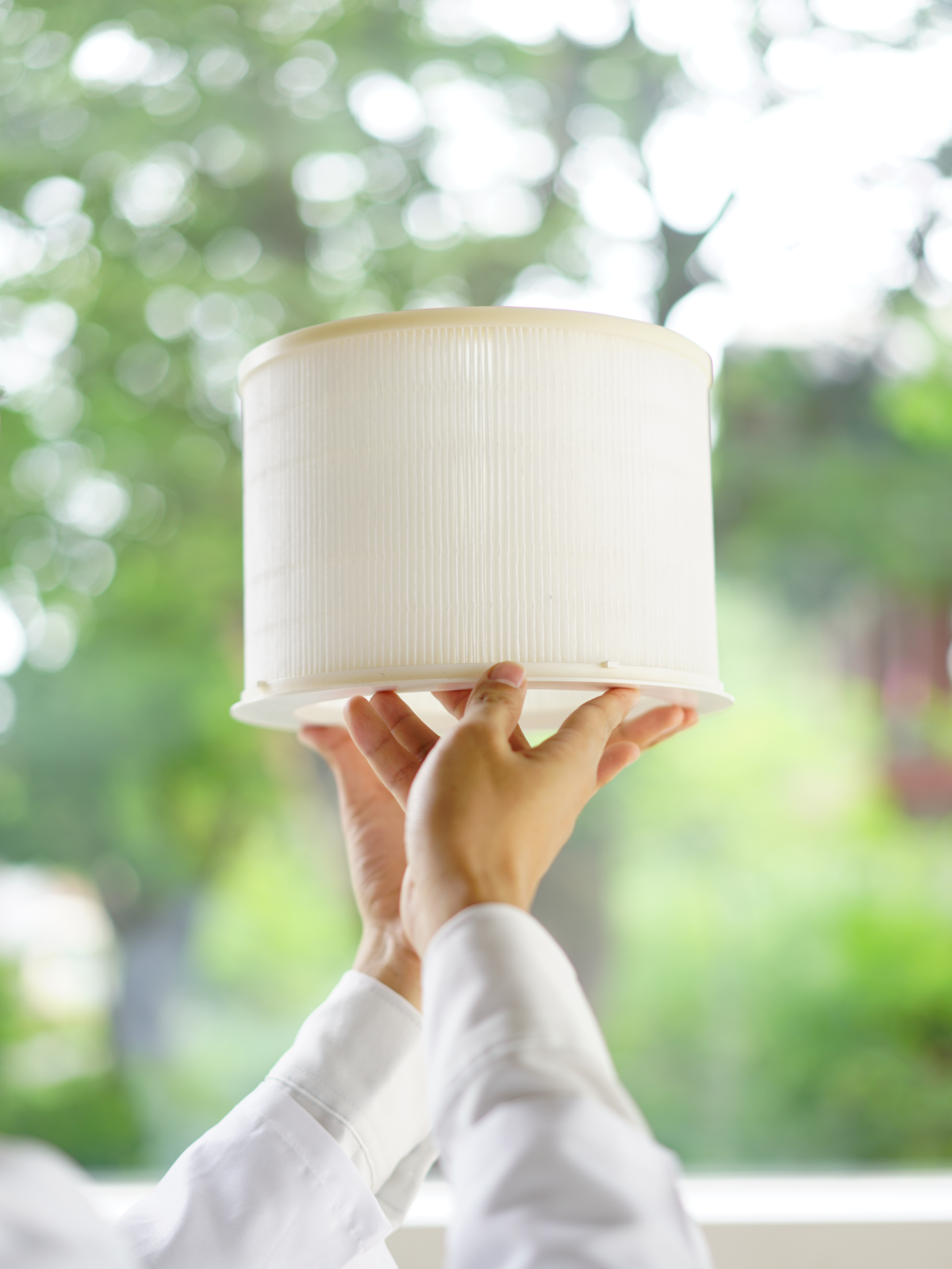 Two hands holding up Zenwell nano air filter