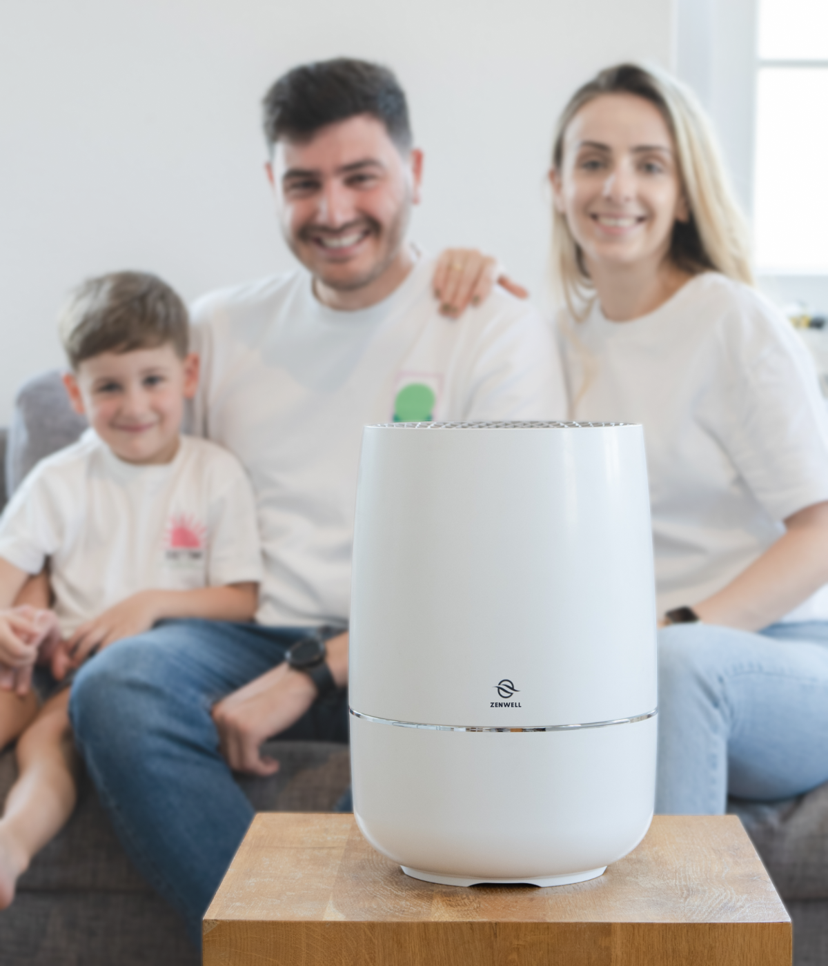 Young son, dad, and mother sitting together behind Zenwell appliance
