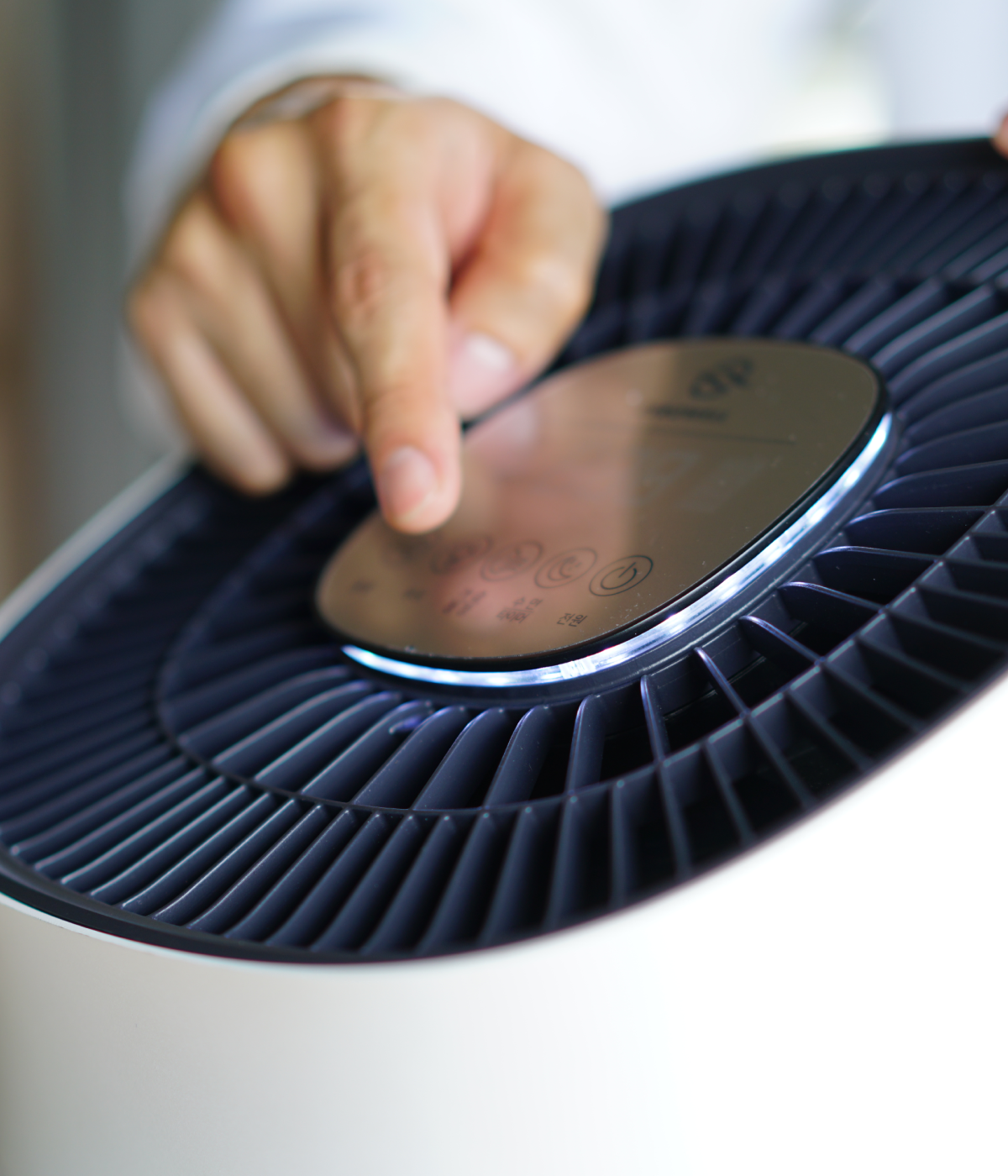 Hand adjusting wind speed on Zenwell appliance using touch display