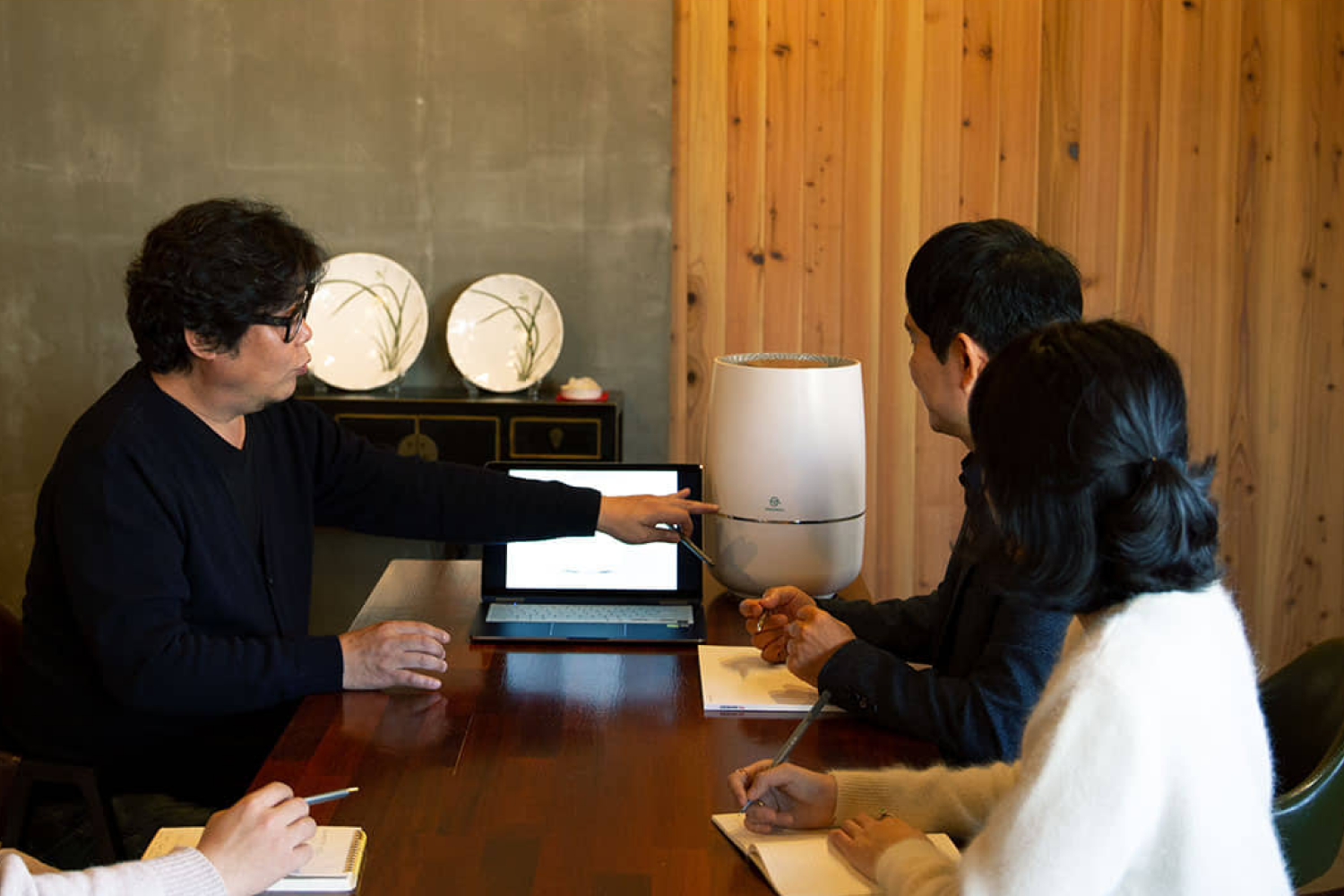 Zenwell design team at table discussing details of Zenwell appliance