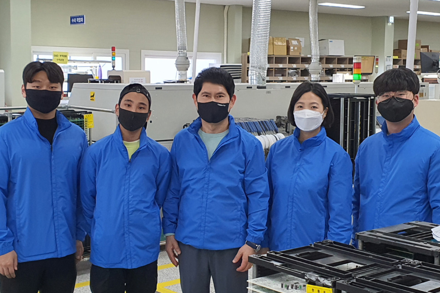Group picture of Zenwell team in uniform in factory
