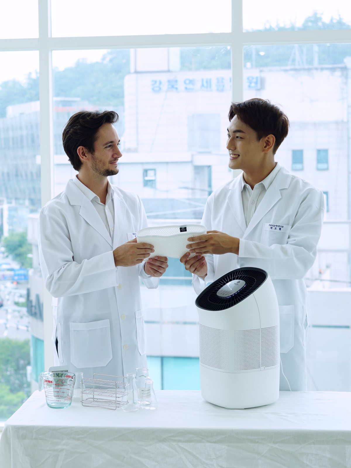 Two men in labcoats smiling and holding Zenwell's washable humidifier filter
