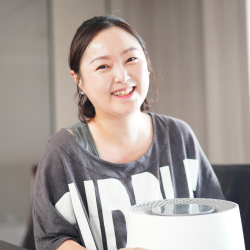 Smiling woman holding Zenwell appliance